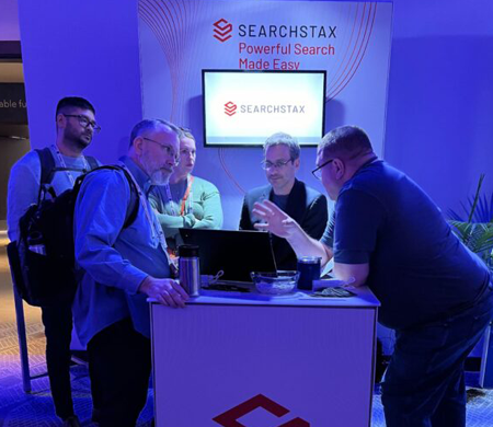 SearchStax team members interacting with attendees at an exhibition