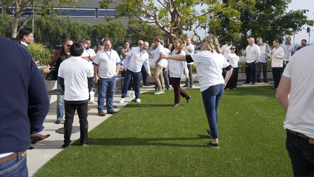 SearchStax employees participating in an outdoor team-building activity on the office lawn